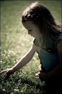 little girl picking flower at brookside gardens in maryland