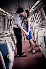 man and woman standing in metro car