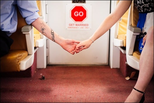 couple holding hands on dc metro car