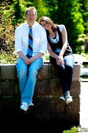 man and woman sitting on wall  at Brookside Gardens in Wheaton MD