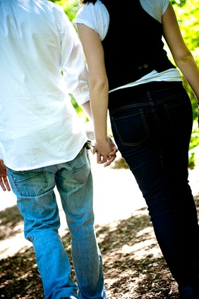 man and woman walking holding hand  at Brookside Gardens in Wheaton MD