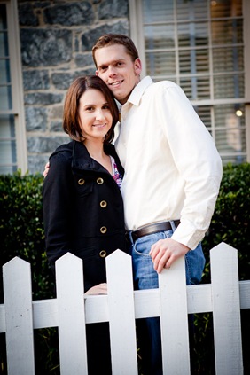 man and woman in Ellicott City in front of white picket fence