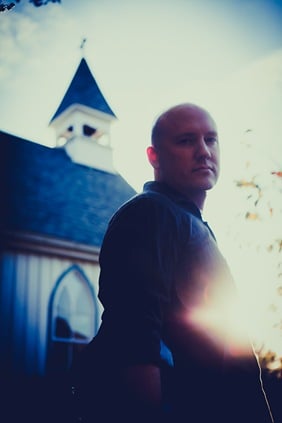Randy Morser in front of church