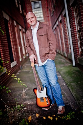 Randy Morser standing with his guitar