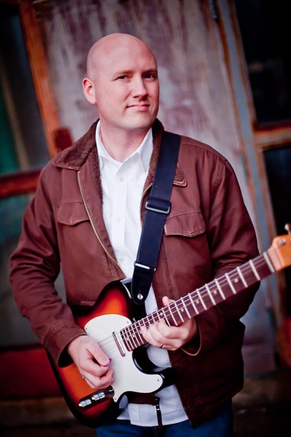 Randy Morser holding his guitar