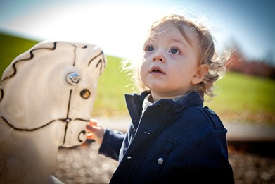 Boy playing with rocking horse at playground in Derwood Maryland