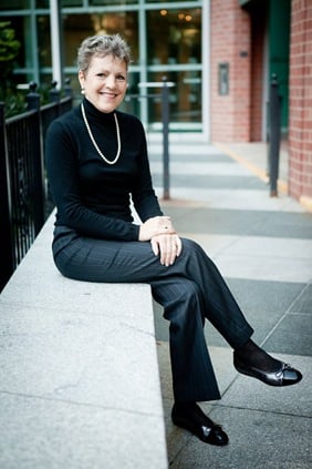 Woman sitting on ledge in front of office  in fairfax va