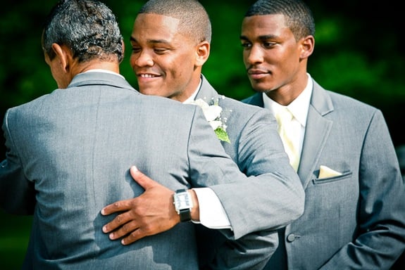 groom hugging father in law  at the Newton White Mansion in Mitchellville MD