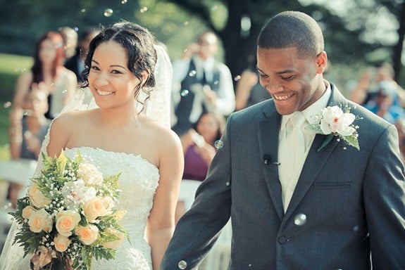 bride and groom walking down isle at the Newton White Mansion in Mitchellville MD