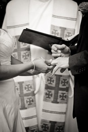bride placing ring on grooms finger at Mt. Airy Mansion in Upper Marlboro Maryland
