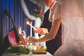 Bride and groom lighting unity candle in Mechanicsville MD