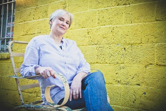 woman sitting outside local business in old town alexandria