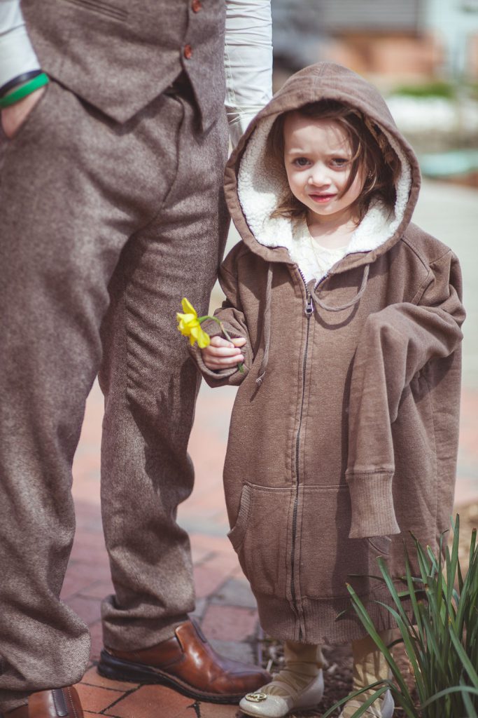 Cute little girl wearing a sweatshirt that is too big.