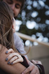 A man and woman engaged in a loving embrace on a staircase in Downtown Annapolis.