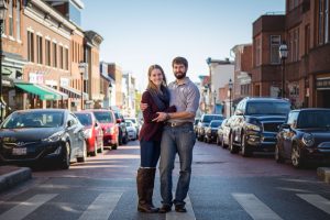 A couple standing in the middle of a city street in Downtown Annapolis, captured in a timeless portrait.