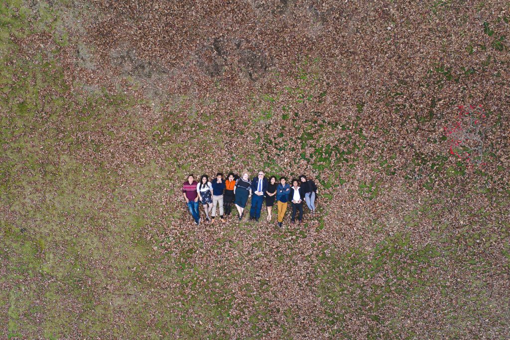 A group of people standing in a field.