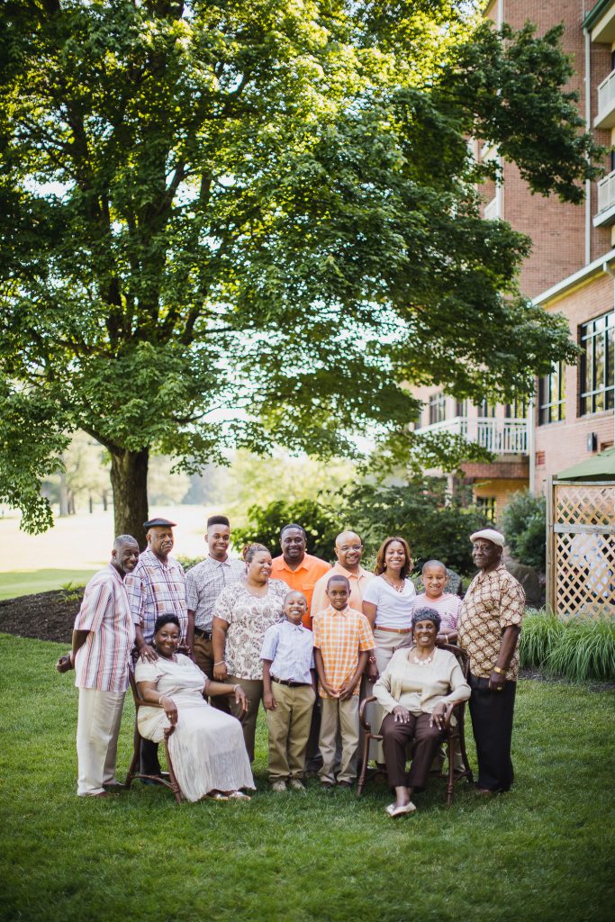 A group of people posing in front of a building.
