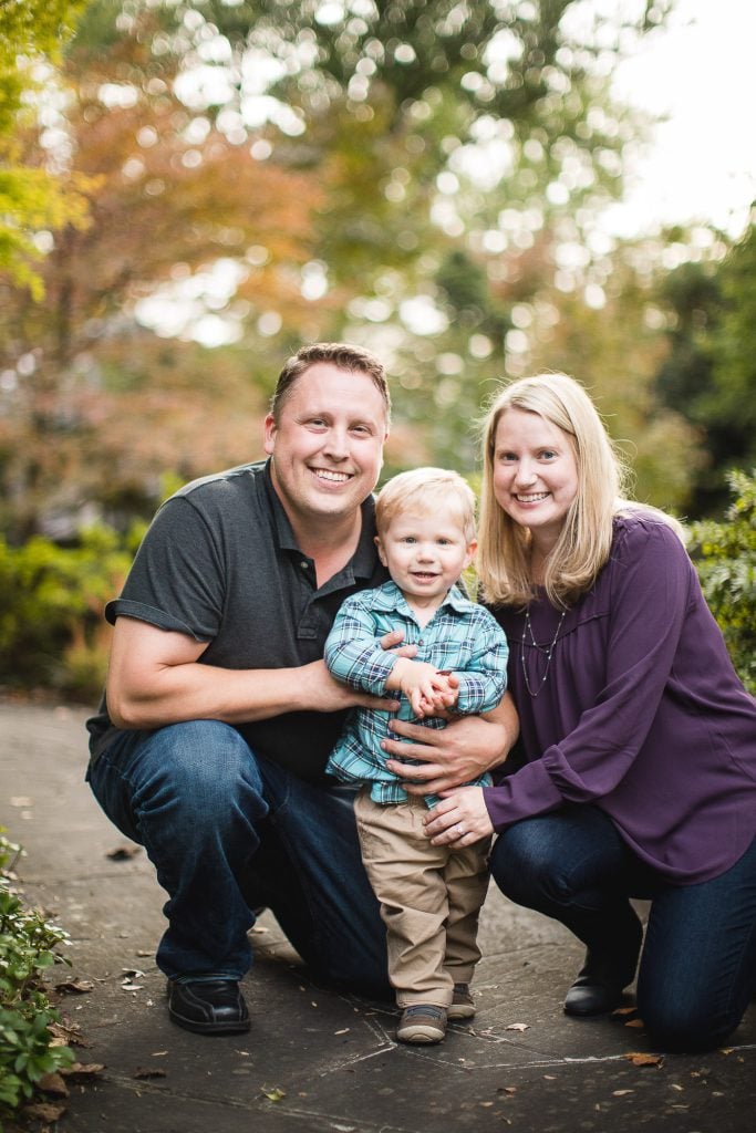 A family posing for a photo in a park.