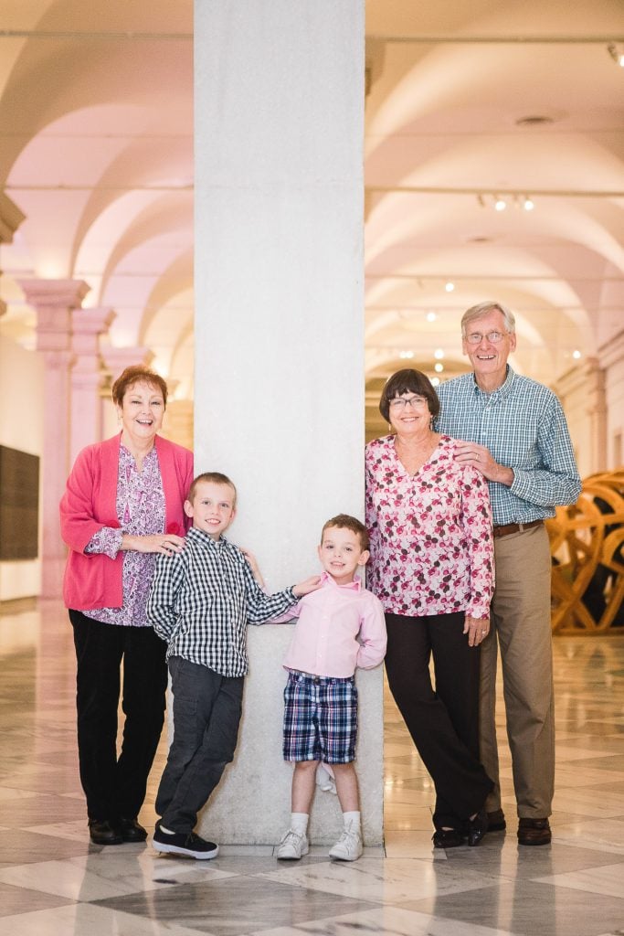 A family posing for a photo in a museum.