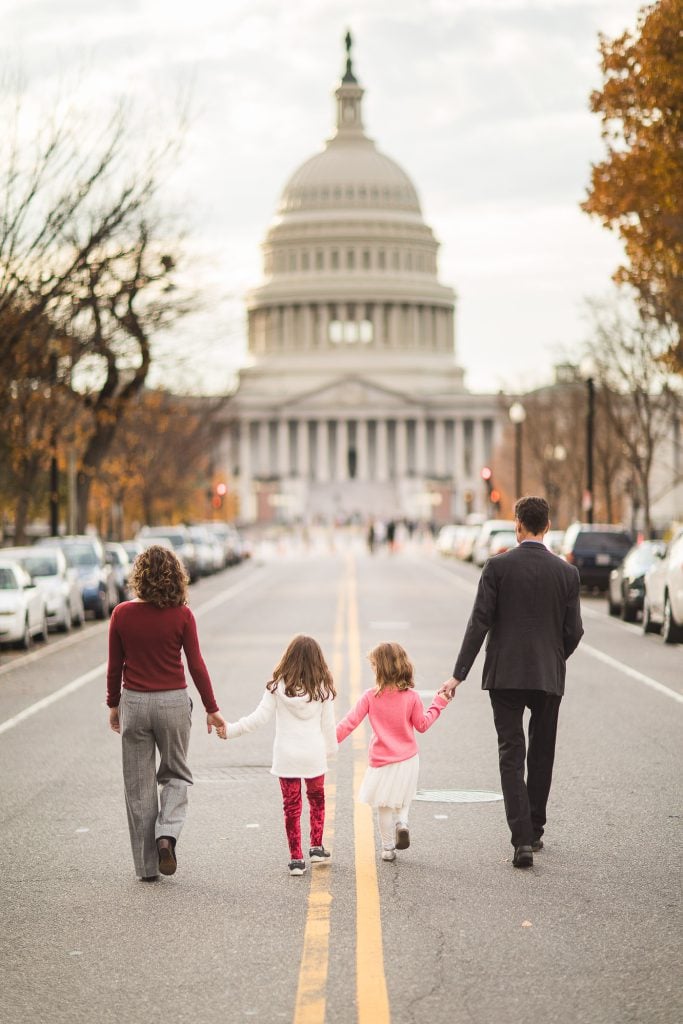A family poses for a portrait in front of the capitol building.