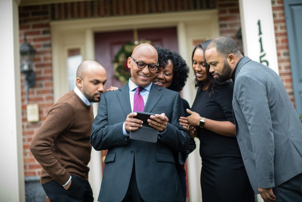 A family portrait in front of a house.