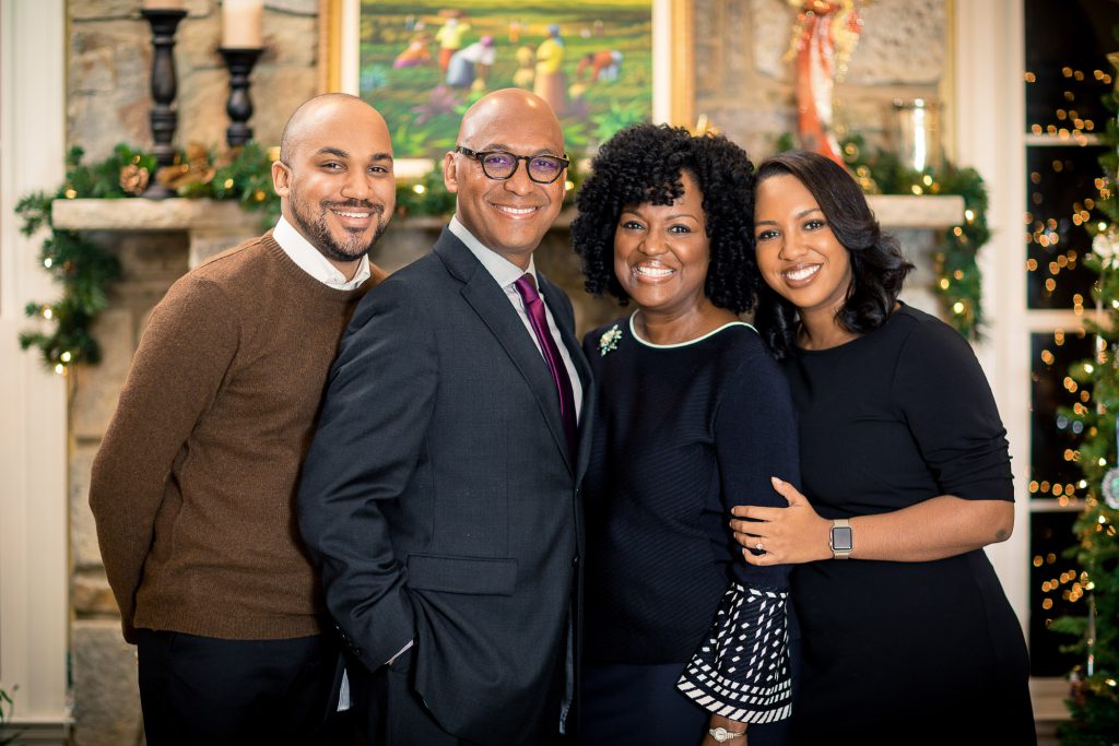 A family portrait in front of a Christmas tree.