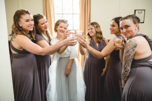 A group of bridesmaids toasting a glass of wine at an Annapolis wedding.