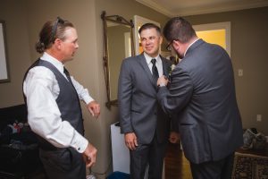 Three men in suits preparing for a wedding captured by a Maryland wedding photographer.