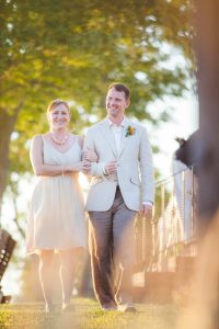 A bride and groom walking down a path at sunset captured by a Maryland Wedding Photographer.