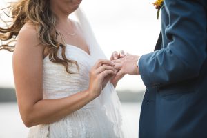 A Bowie wedding photographer capturing the special moment of a bride and groom exchanging wedding rings.