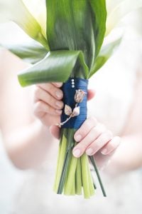 Maryland Wedding Photographer capturing a bride with a bouquet of white lilies and blue ribbon.