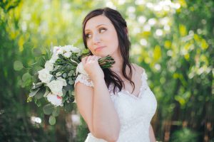 A bride photographed holding a bouquet of white flowers by a Maryland wedding photographer.