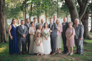 A wedding party posing for a photo in the woods, captured by a Maryland wedding photographer.