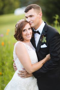 A romantic embrace captured by a Maryland wedding photographer in a field of flowers.