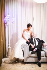 A couple sitting on a couch captured by a Maryland wedding photographer.