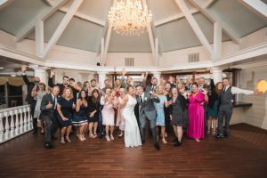A wedding party posing for a photo at a ballroom, captured by a talented Bowie Wedding Photographer.