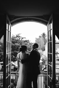 A bride and groom posing for Maryland wedding photography in front of an archway.
