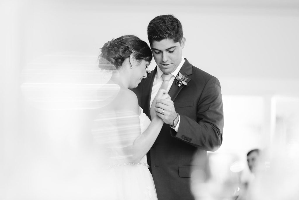 A bride and groom sharing their first dance at their wedding reception.
