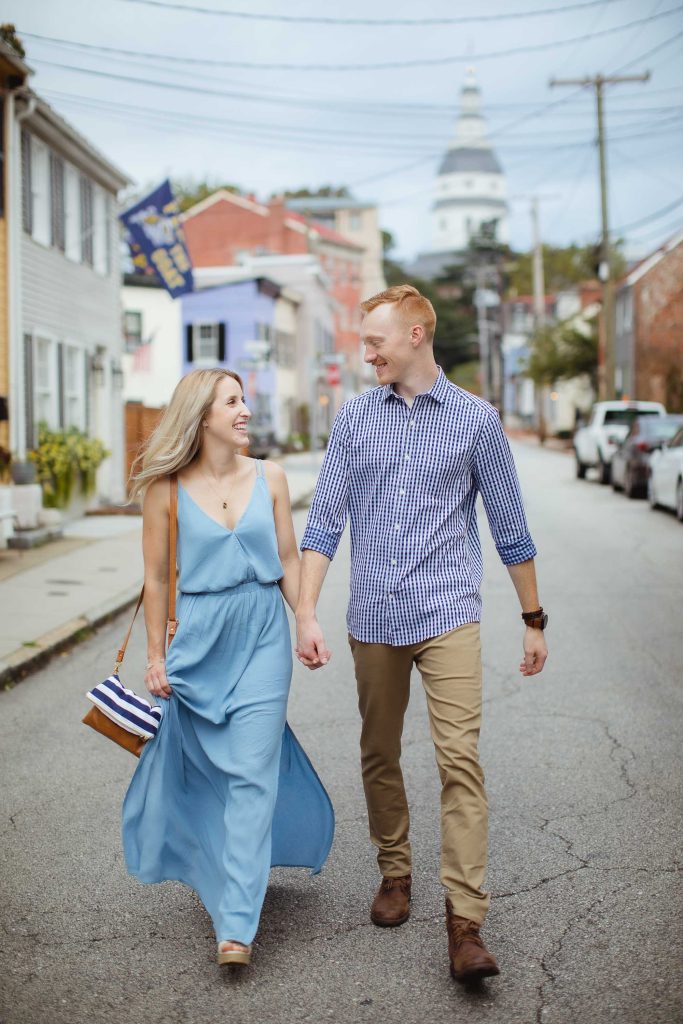An engaged couple walking down a street in Downtown Charlottesville, Virginia.