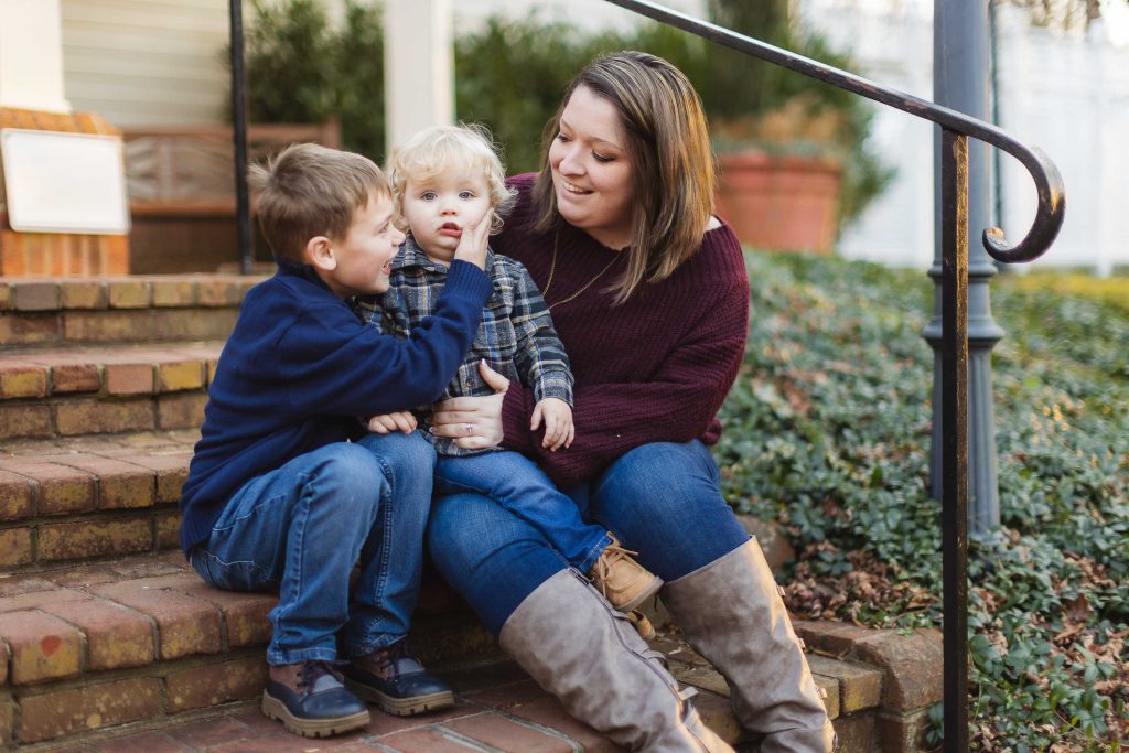 A family enjoys a peaceful moment on the steps of their home.
