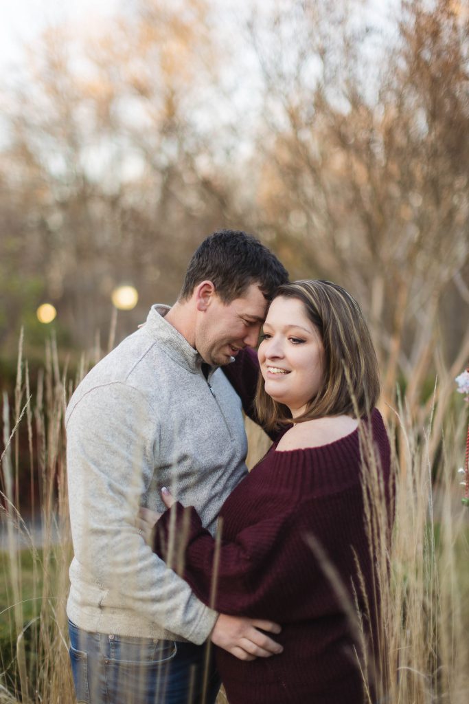 A couple embraces during their quiet waters park engagement session.