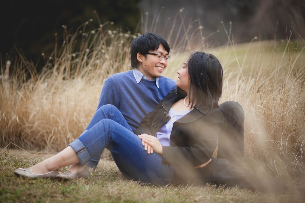 An Asian couple enjoying the serene beauty of tall grass in Brookside Gardens, Maryland.