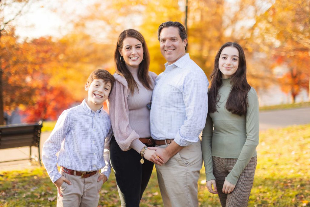A family is posing for a photo in Federal Hill Park.