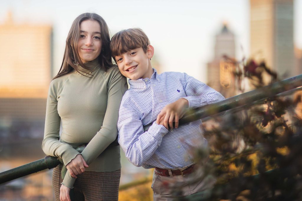 A boy and a girl posing for portraits in Federal Hill Park.