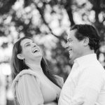 A black and white portrait of an engaged couple laughing in Baltimore.