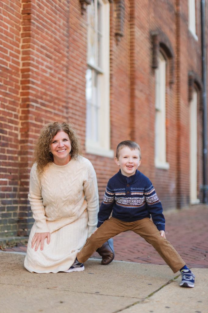 A family poses in front of a brick building in downtown Annapolis.