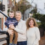 A Downtown Annapolis family posing for a portrait in front of a house.