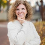 A woman with curly hair standing in downtown Annapolis.