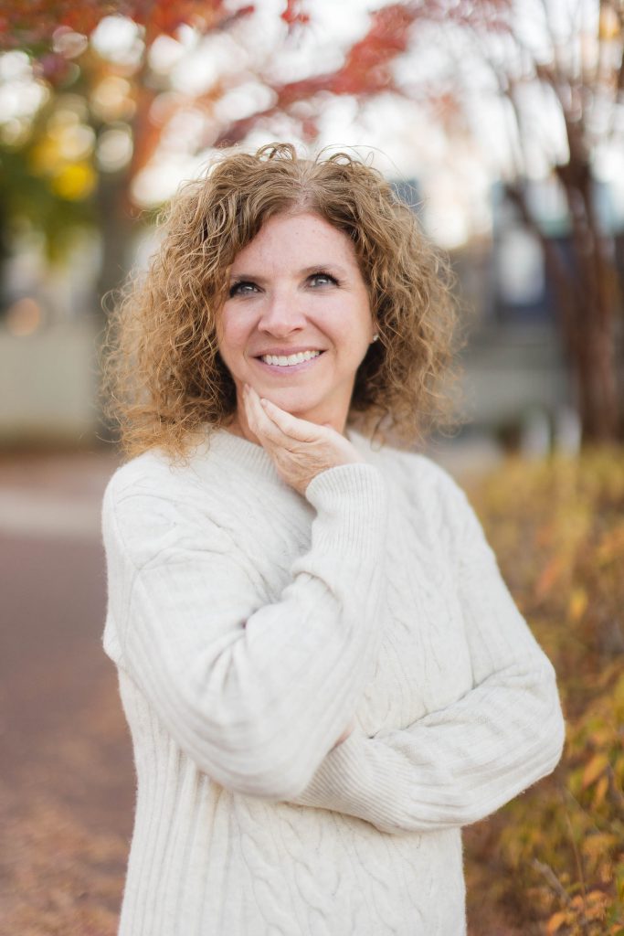 A woman with curly hair standing in downtown Annapolis.