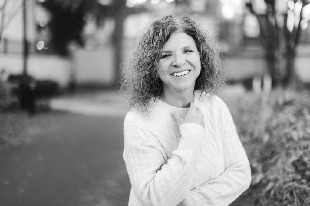 A black and white portrait of a woman with curly hair in Downtown Annapolis.